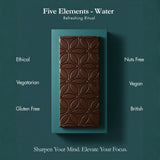 A chocolate bar with an embossed geometric pattern, presented on a teal rectangular card against a dark teal background. White text around the product reads 'Five Elements - Water', 'Refreshing Ritual', and lists attributes like Ethical, Nuts Free, Vegan, Gluten Free, and British.